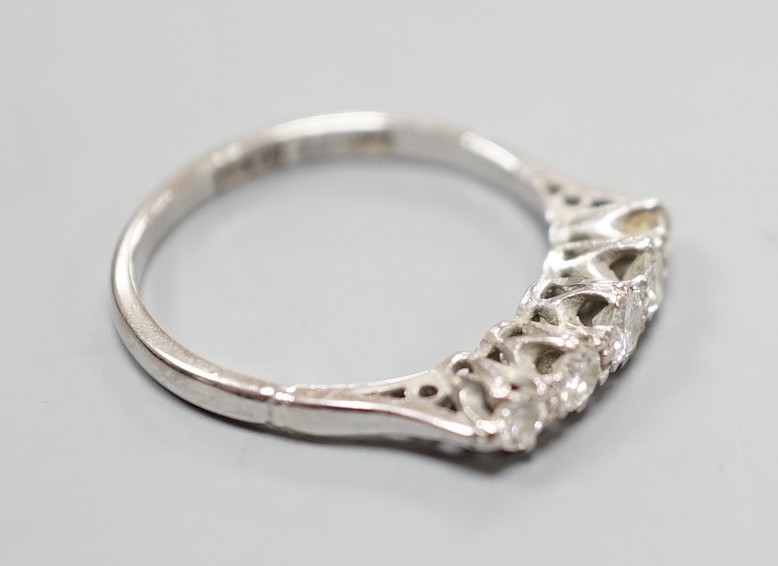 A plat and 18ct five stone diamond set half hoop ring, size K, gross weight 2 grams.